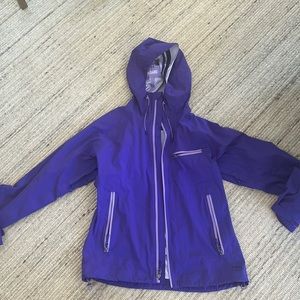 Purple REI rain jacket with duckbill hood